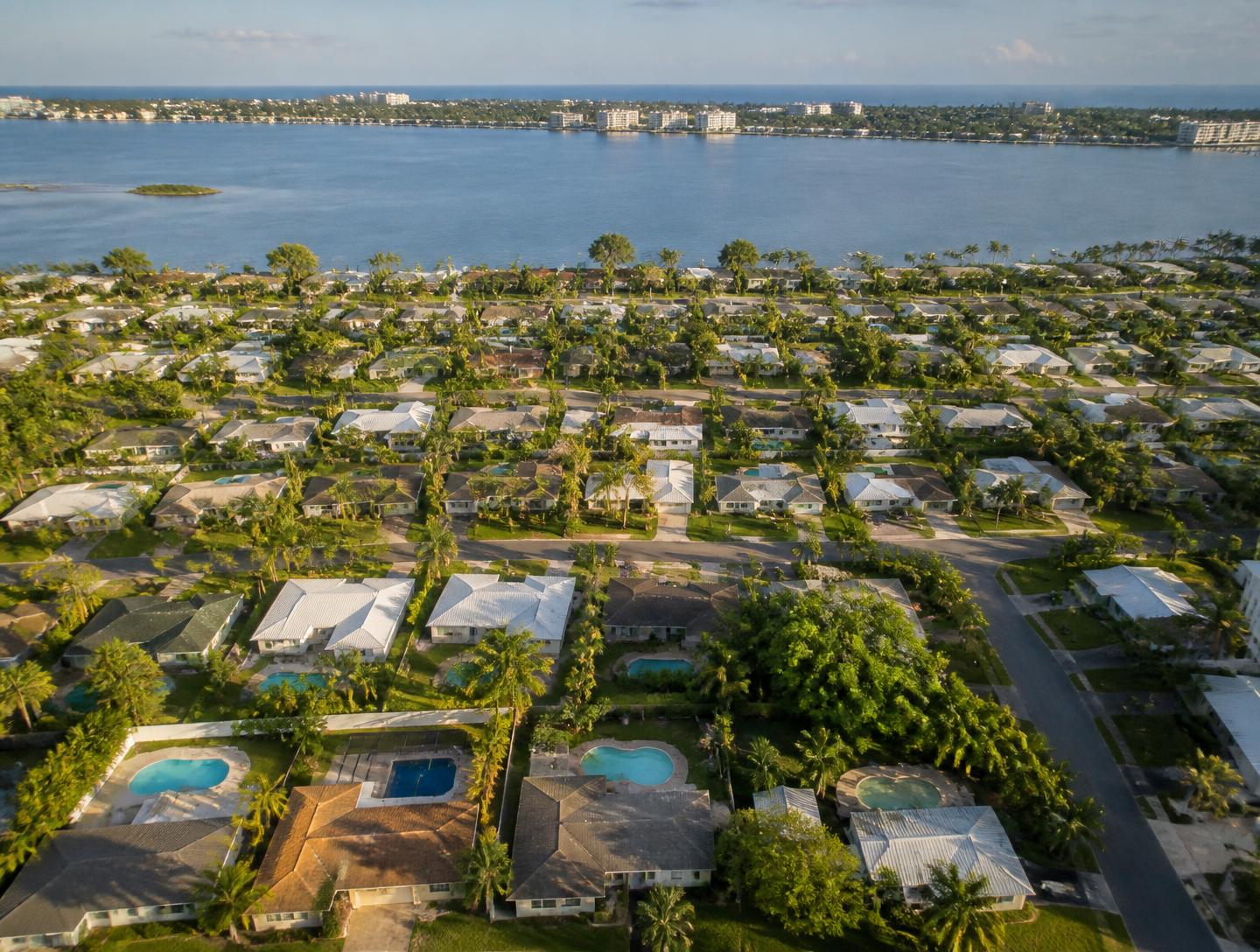Aerial view of Brevard County coastal neighborhoods with backyard swimming pools along the Indian River